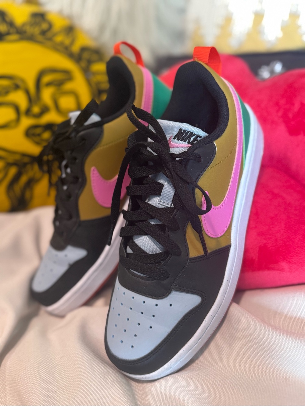 Nike Low-Top Court Buroughs in Pink, Old Gold, Green, Black & Pale Blue.